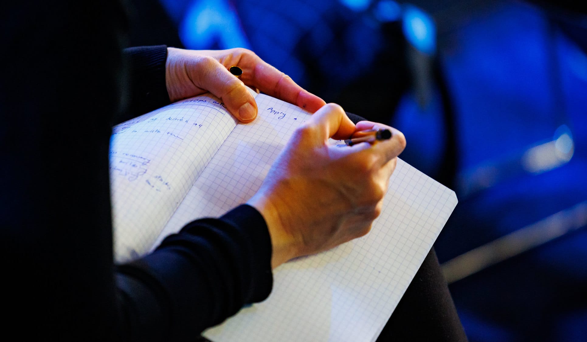 Woman writing on a pad of paper